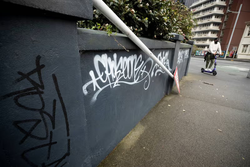 Pedestrian riding through graffiti