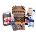 A comprehensive Graff-Attak-Pak graffiti removal system kit displayed on a clean white background. The kit includes a large jug of dark liquid, a pink bottle of cleaning solution, a cardboard box of safety gloves, a brush, a can of compressed air, a box of safety wipes, and an instruction manual.