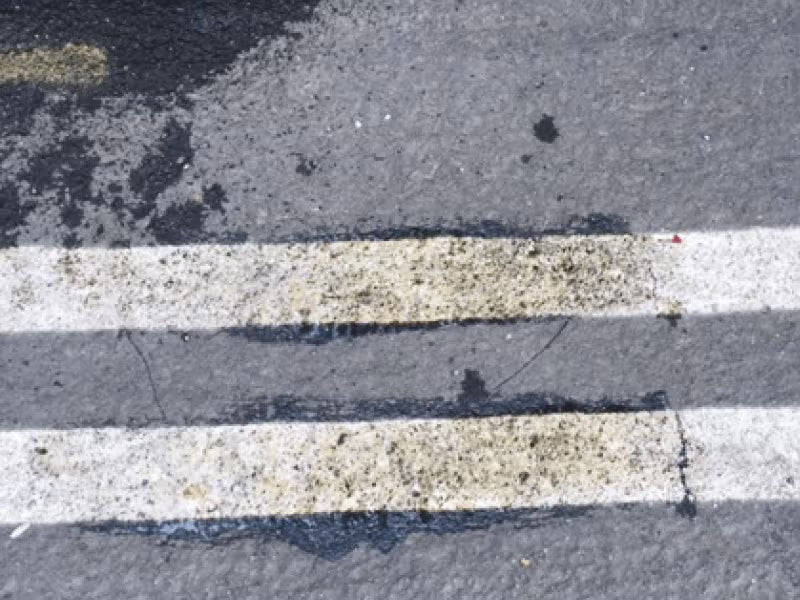 White line striping on asphalt removal.
