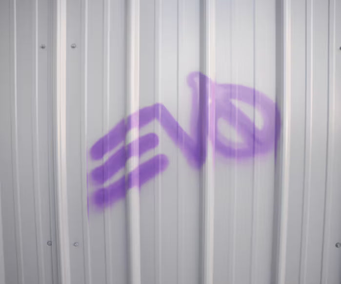Spray paint graffiti markings on surface coated with Valspar ASTM-compliant coating.