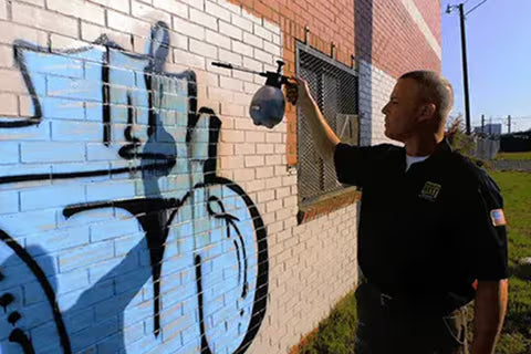 Paul Watts from GRS removing graffiti from Painted Wall