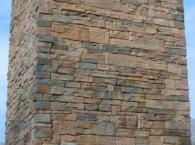 Close-up of a stone wall with a blue sky background