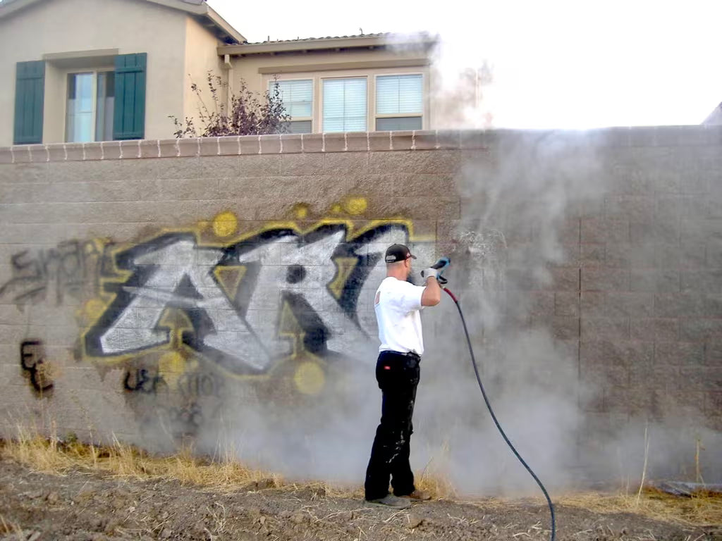 Graffiti removal from brick using proper pressure washing equipment.